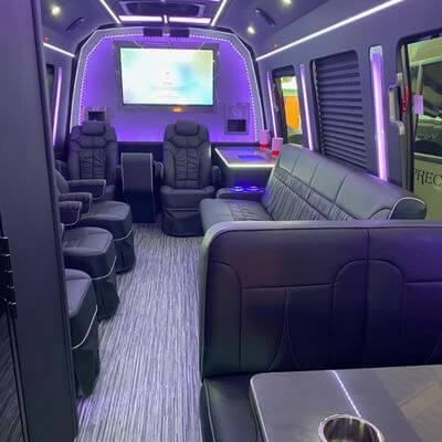 14 Passenger bus interior with big screen, leather chairs and benches